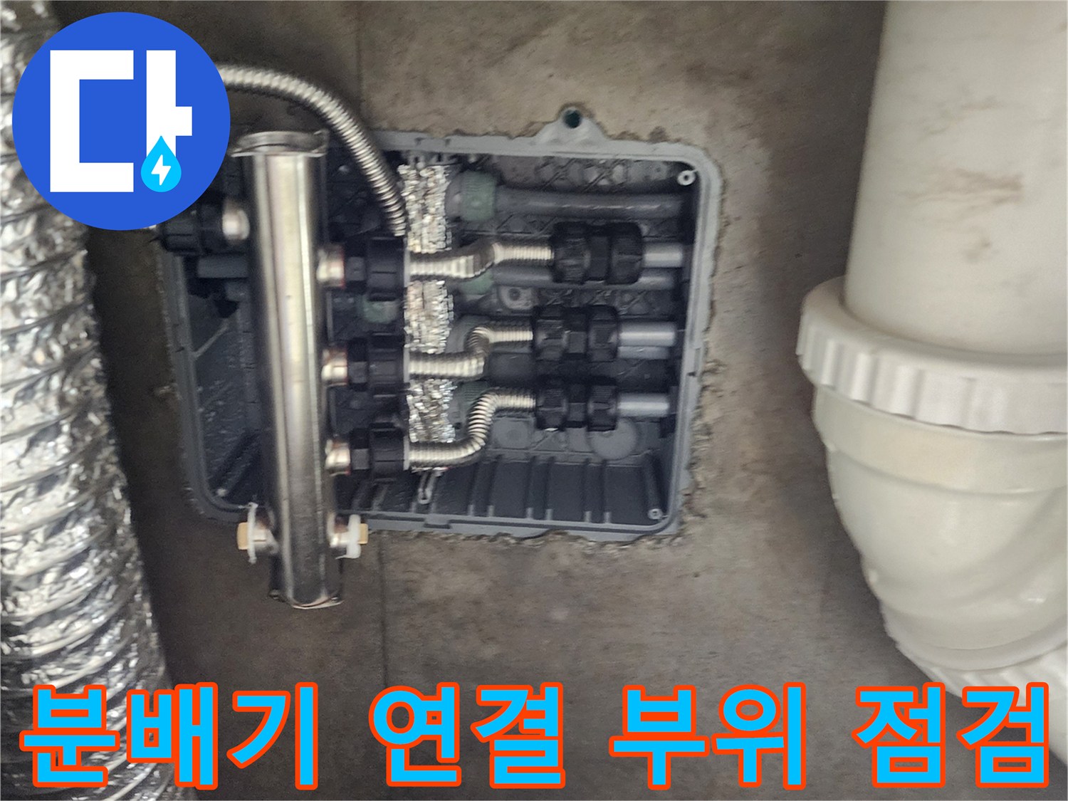 주방 싱크대 아래 매립된 분배기와 배관들의 연결 상태 사진