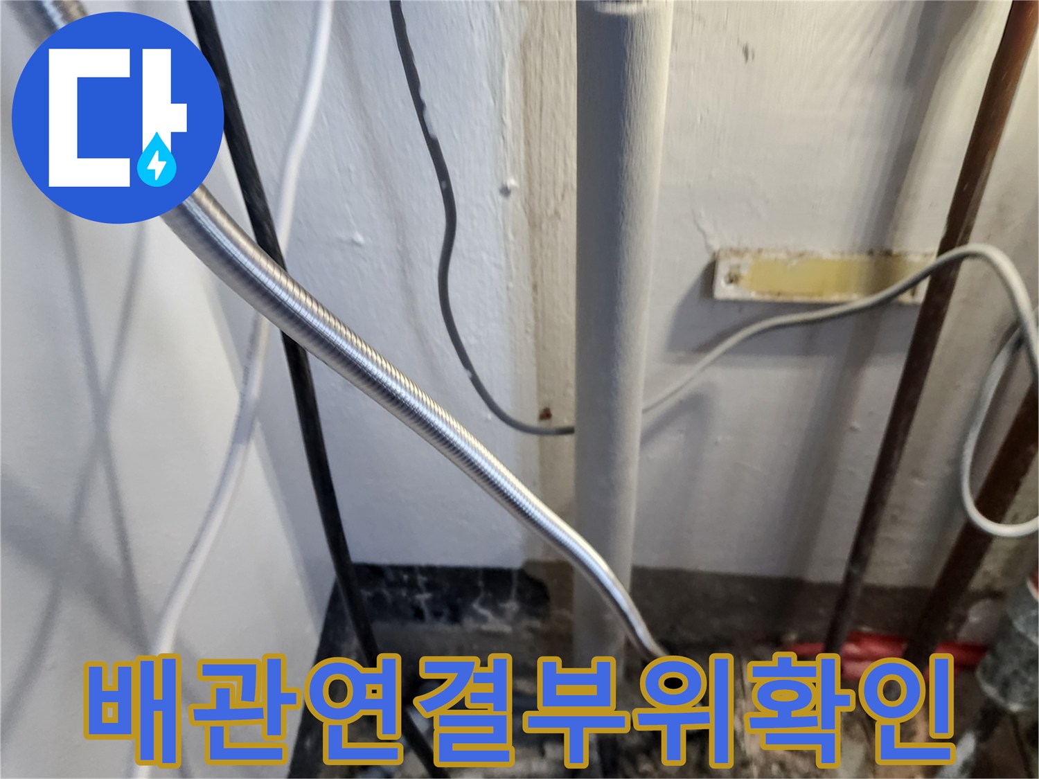 벽면 배관과 연결된 은색 호스 및 부속의 누수 의심 구간