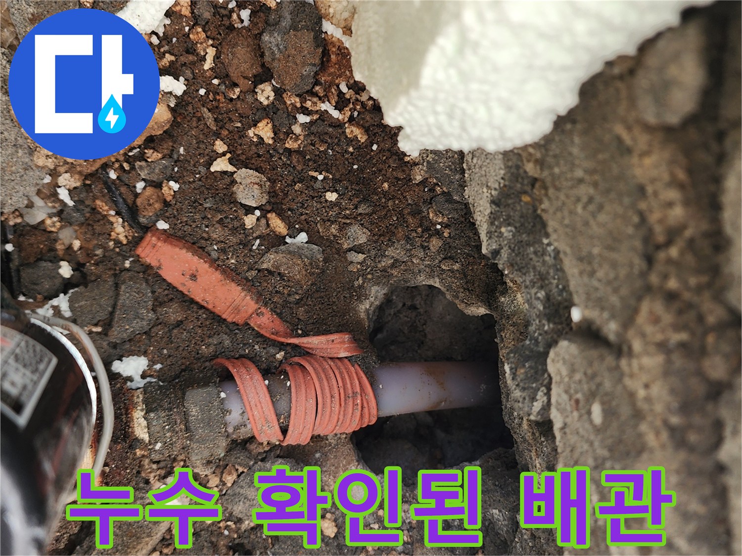 시멘트 벽면 아래 드러난 누수 배관 부위