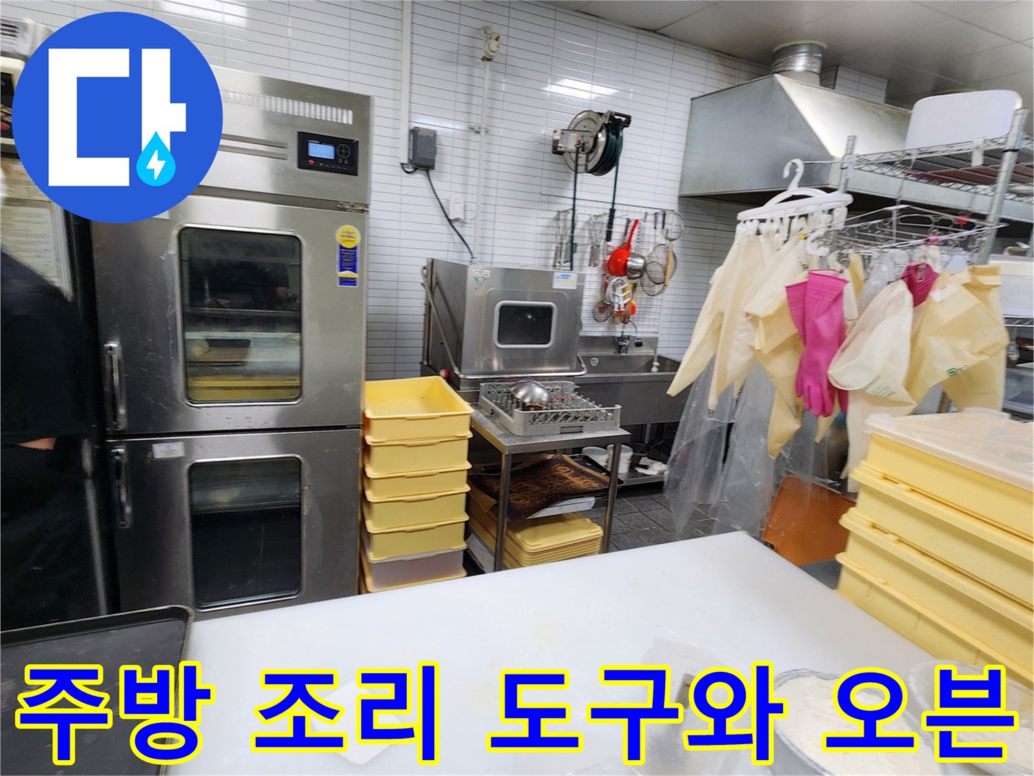 카페 주방 내부의 스테인리스 오븐과 위생 장갑이 걸린 모습입니다.