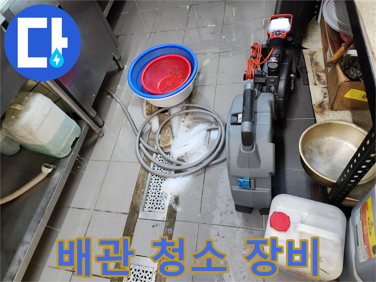 현장에 배치된 산업용 진공 흡입기와 배수 용기