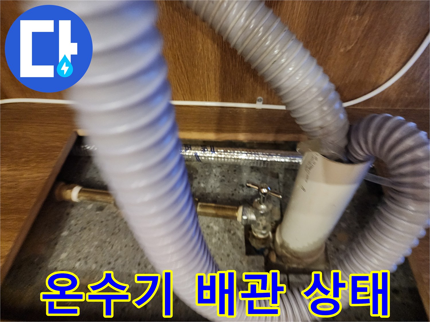 주방 하부장 내 설치된 전기 온수기와 연결 호스 상태
