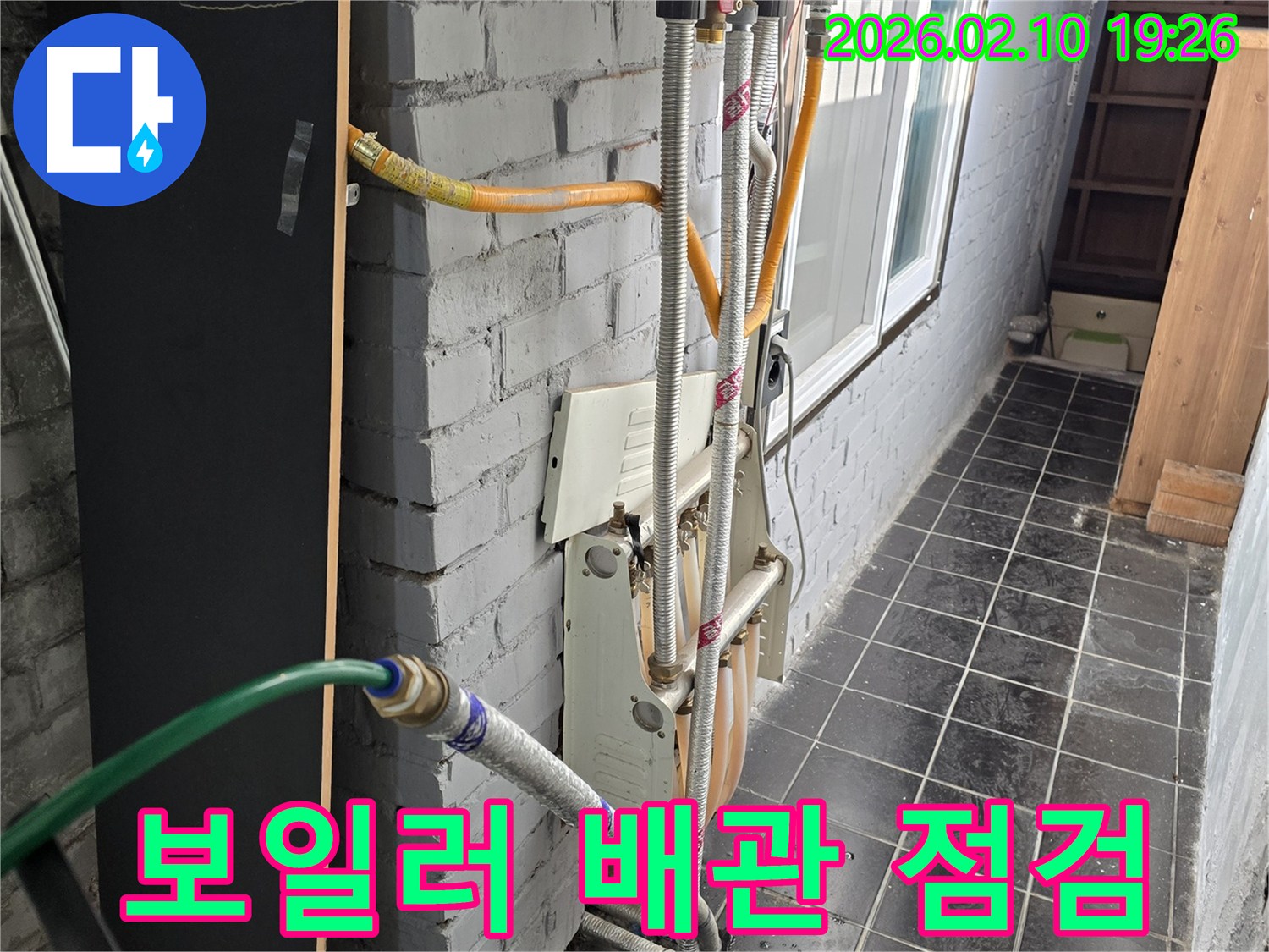 누수 공사 현장에서 보일러 배관을 점검하고-수도 연결 작업을 진행하는 모습