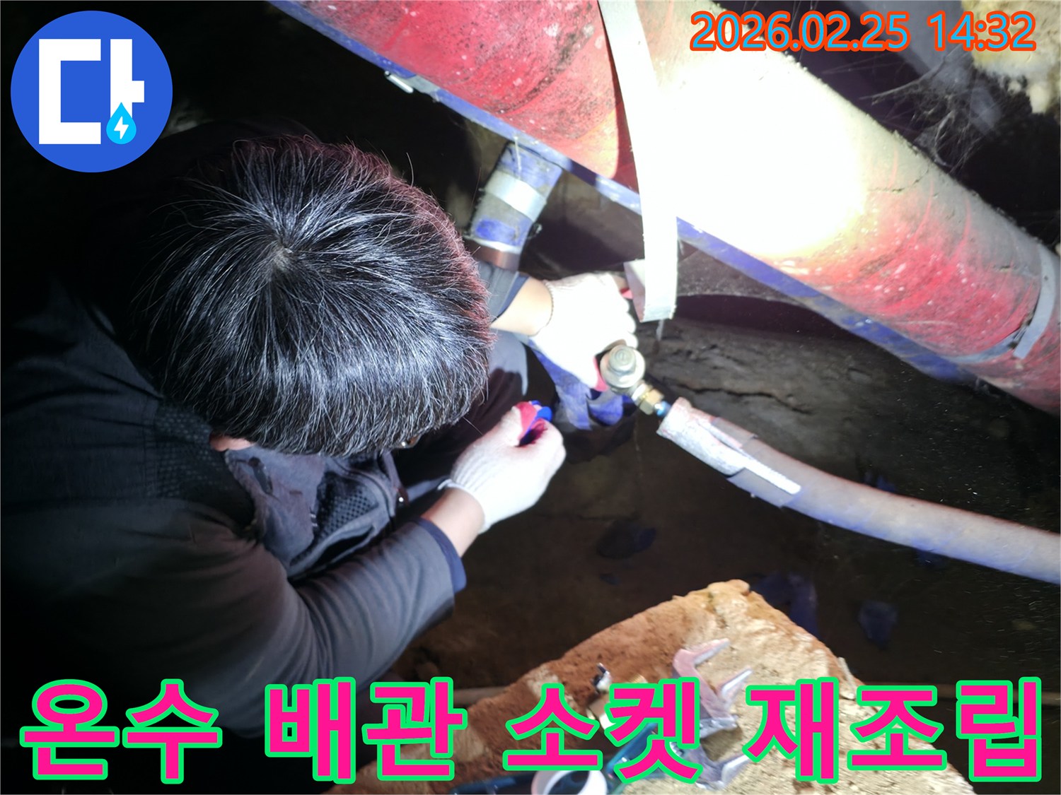 숙련된 누수 기술자가 좁은 공간에서 손전등을 비추며 온수-배관 연결 소켓을 정밀하게 점검하고-꼼꼼하게 재조립하고 있습니다-온수누수해결-전문가수리