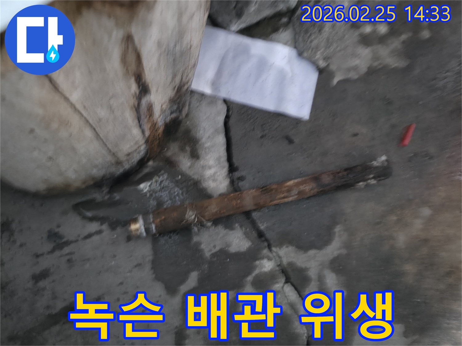 오래되어 녹슬고-부식된 배관이-젖은 바닥에 놓여있는-누수 공사 현장 사진입니다.