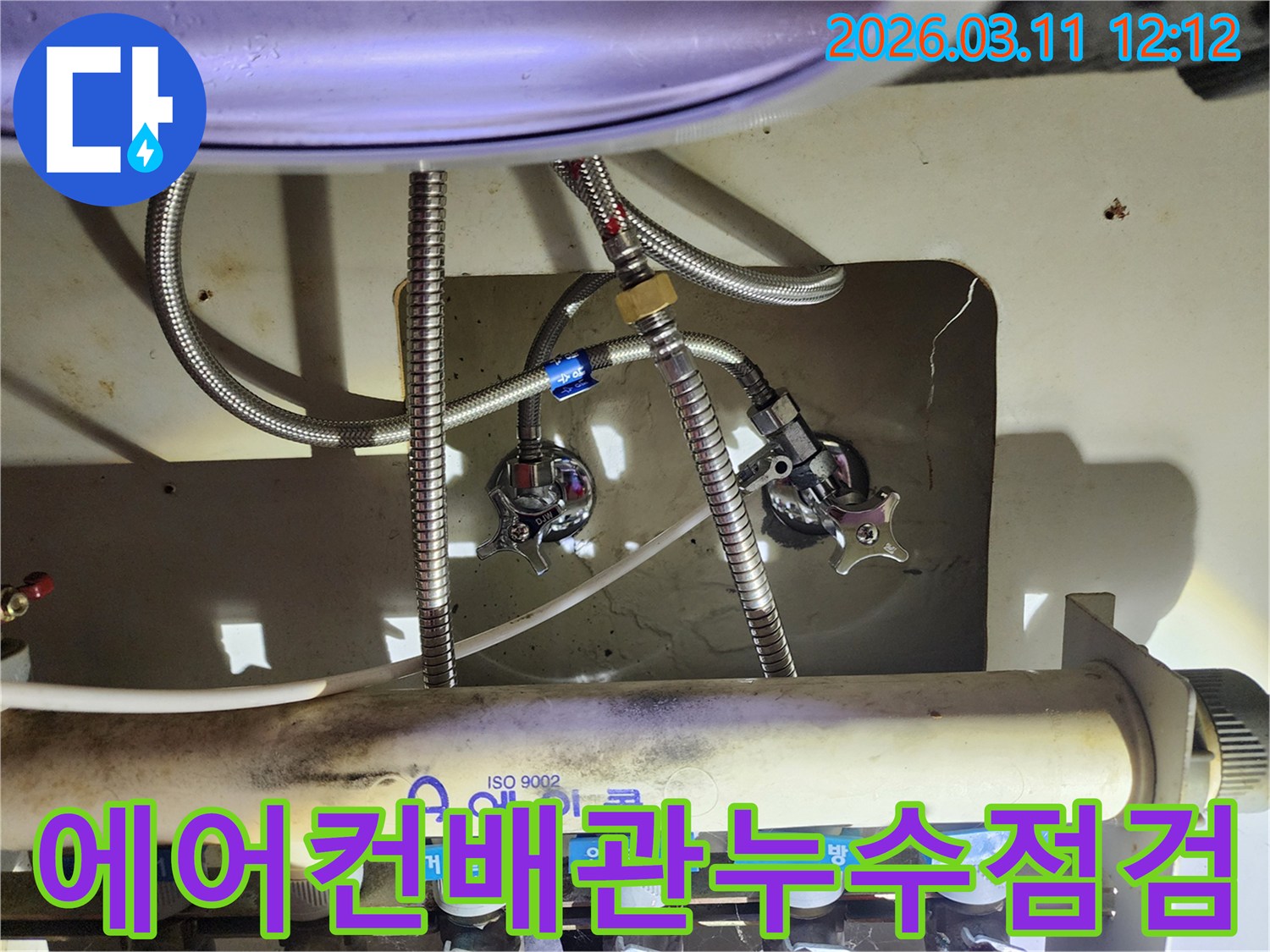 에어컨-배관과-연결된-싱크대-하부-수도-밸브-및-호스-연결-상태를-보여주는-사진