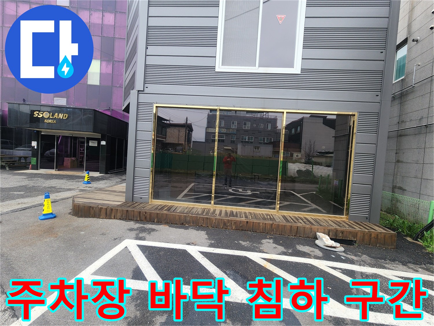 아스팔트 도색 면이 불규칙하게 일그러진 상가 주차장 전경
