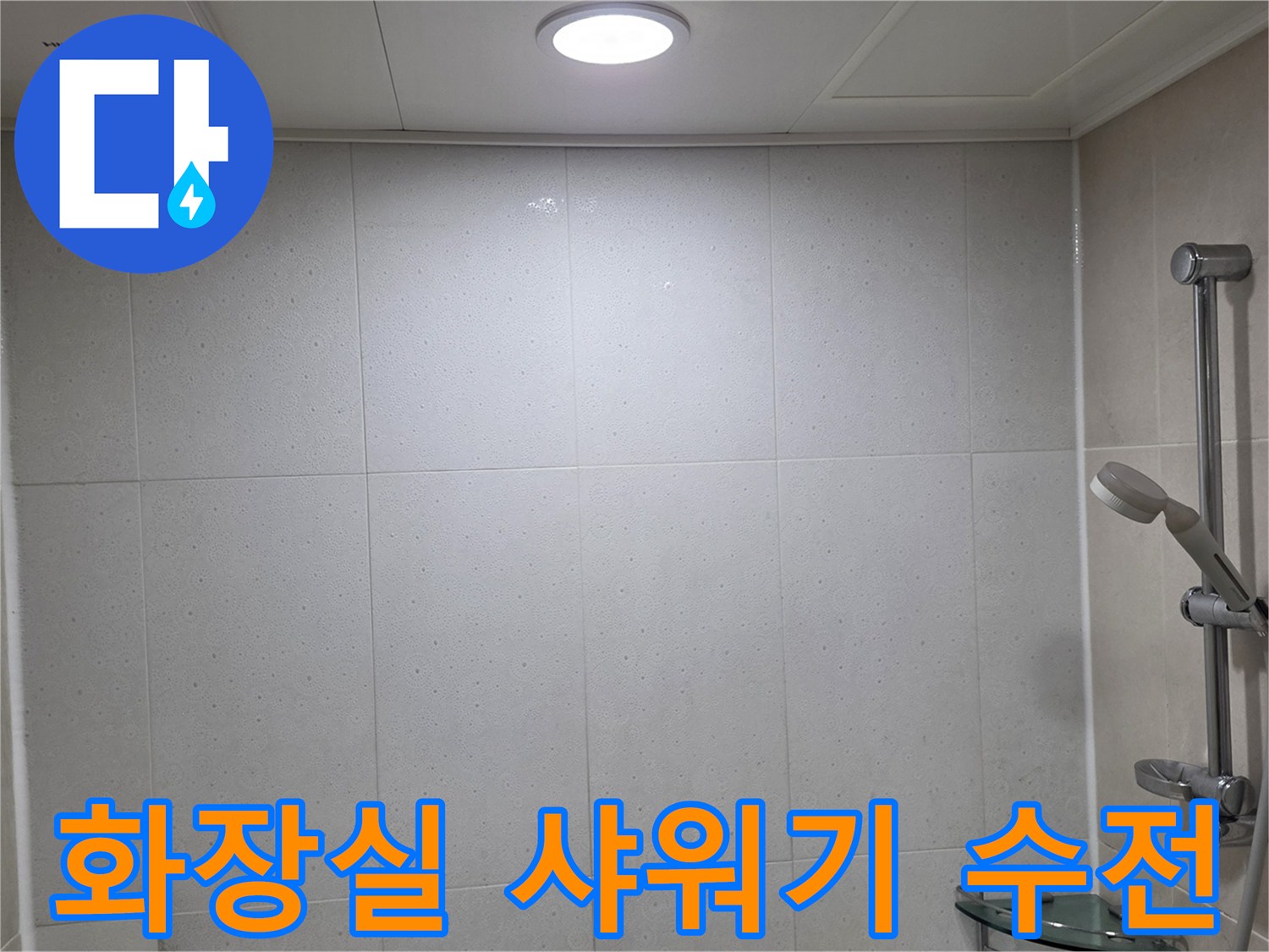 화장실 벽면에 설치된 은색 샤워기 수전과 타일 마감