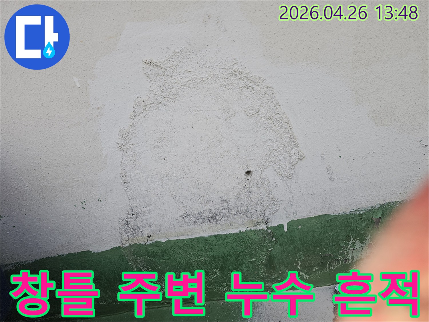 건물 외벽의 창틀 주변에서 발생한 누수로 인해-벽면 마감재가 손상되고-오염된 상태를 보여주는 사진입니다.