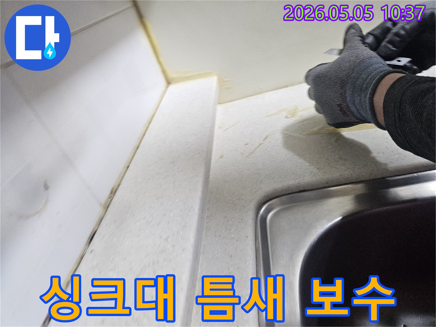 안양 아파트의 싱크대 상판과 벽면 사이-손상된 실리콘을-전문가가 직접 제거하는 모습