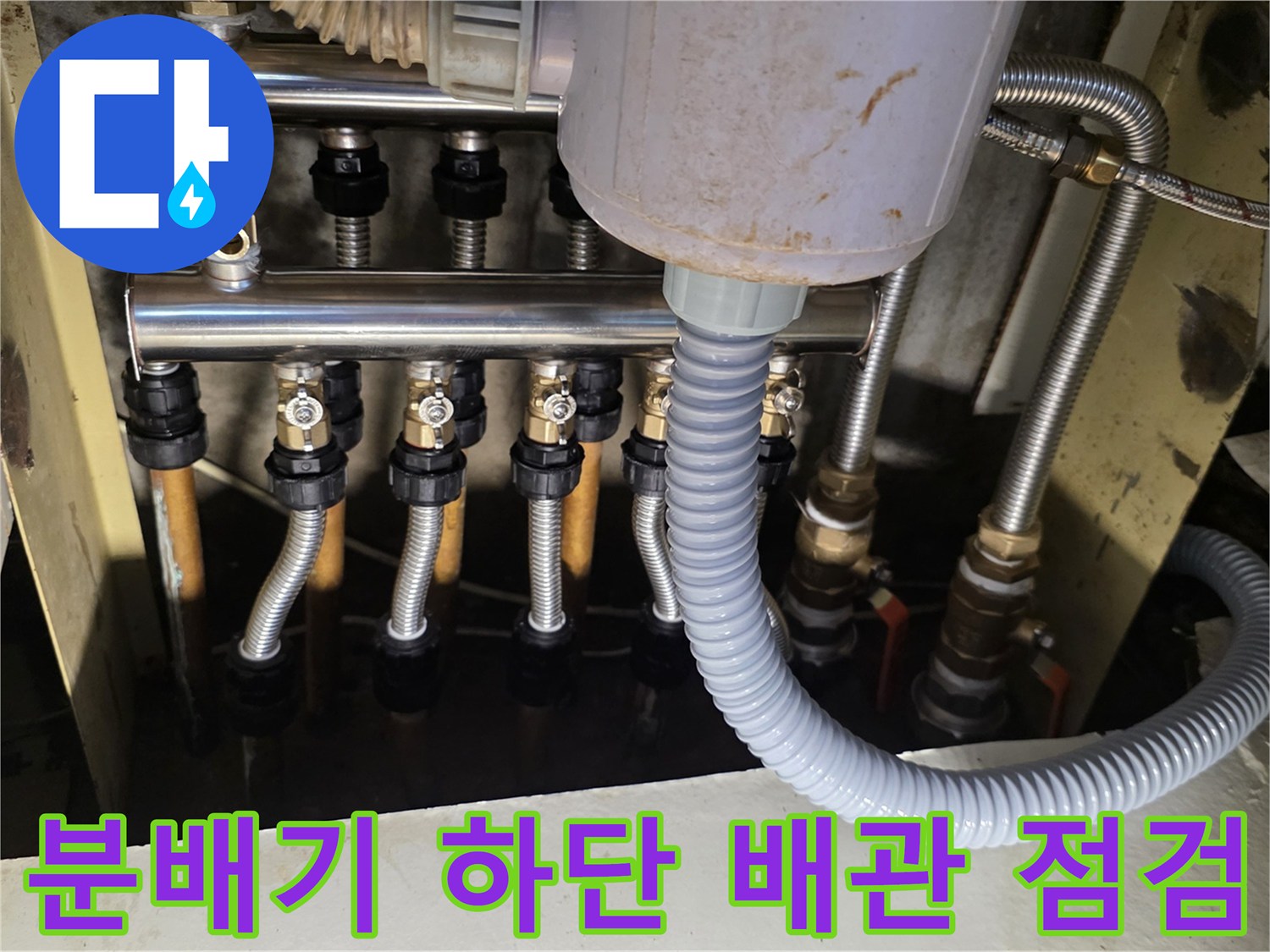 싱크대 아래-보일러 분배기와 연결된 다수의 배관 라인