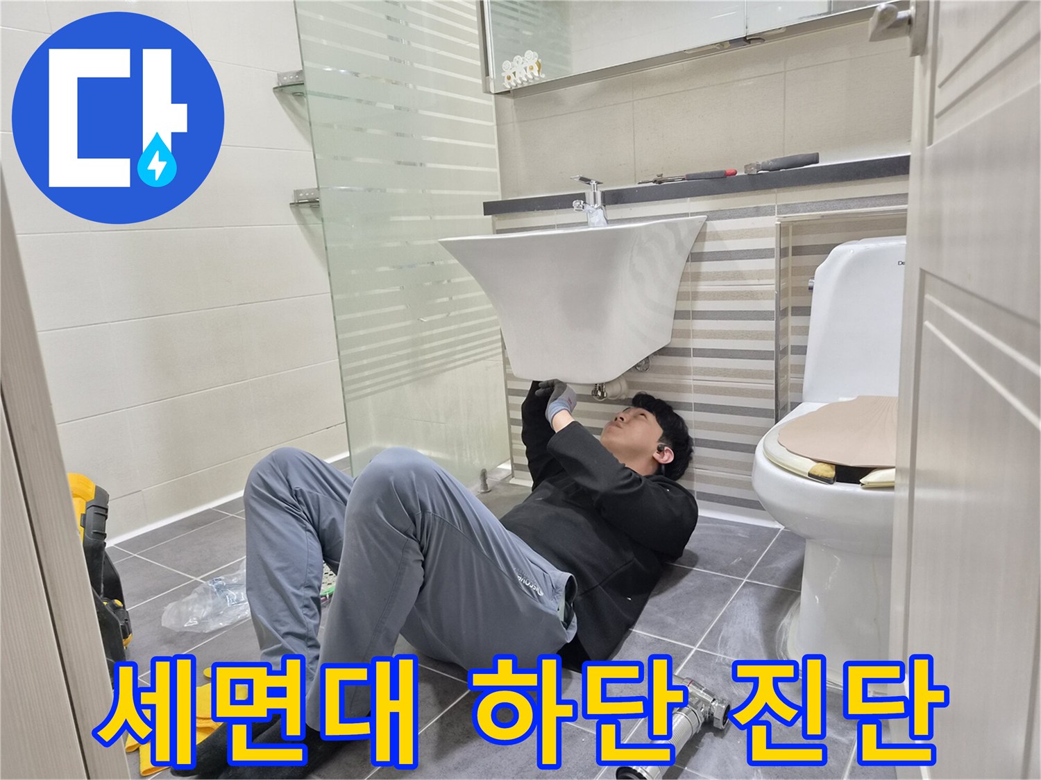 세면대-아래쪽-배관-연결부를-조사하는-작업자