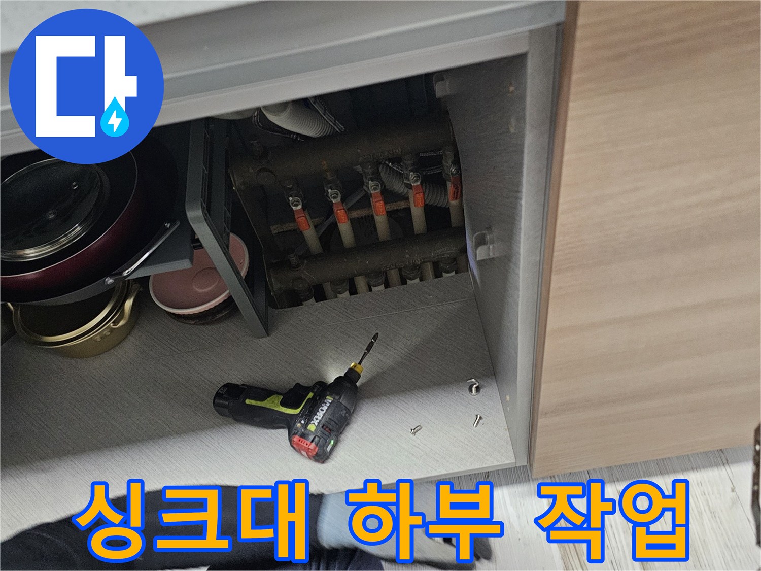 작업자가-싱크대-하부장에서-점검을-진행하는-장면