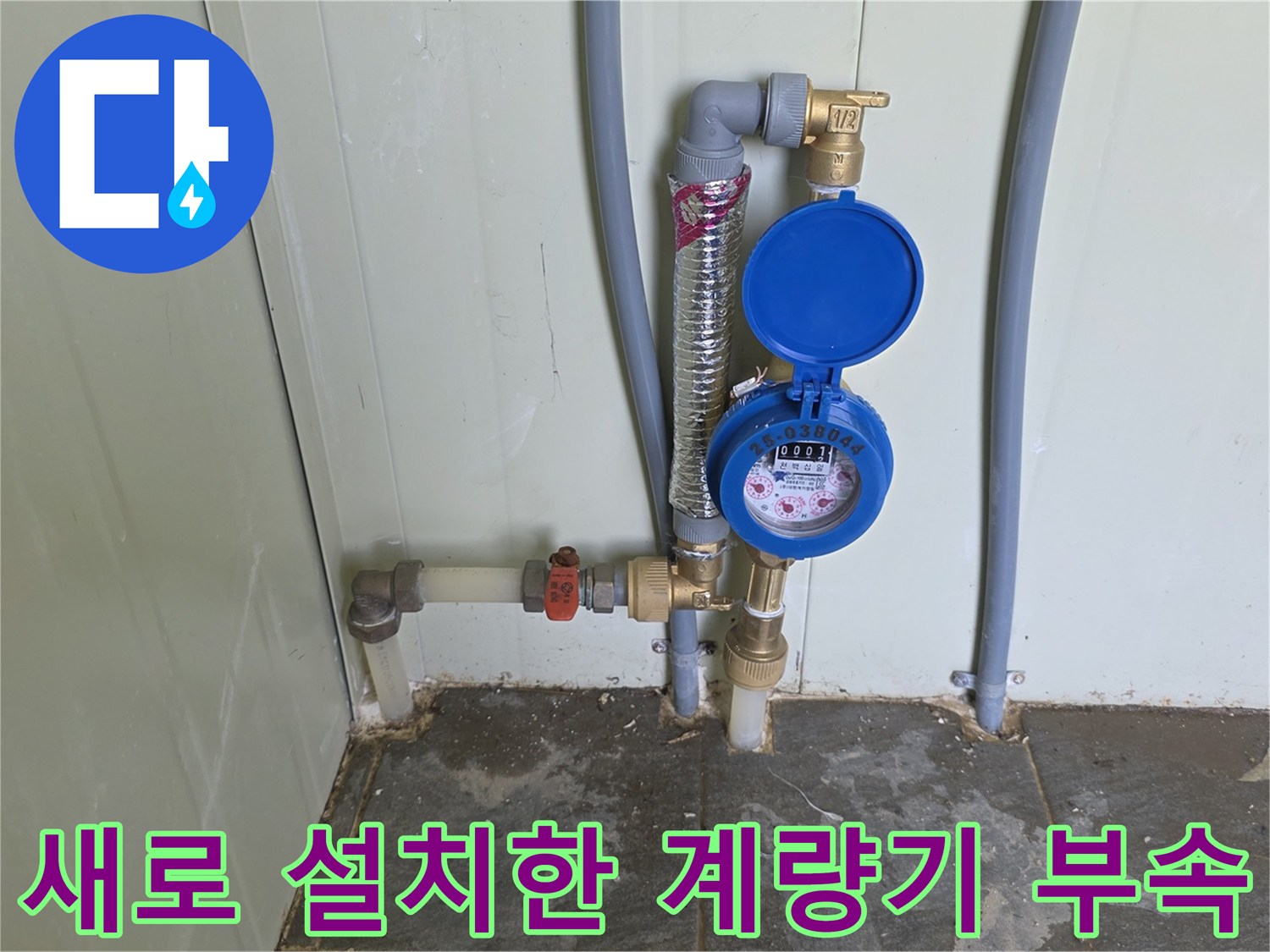 파란색 덮개가 있는 수도 계량기와 연결된 금속 배관
