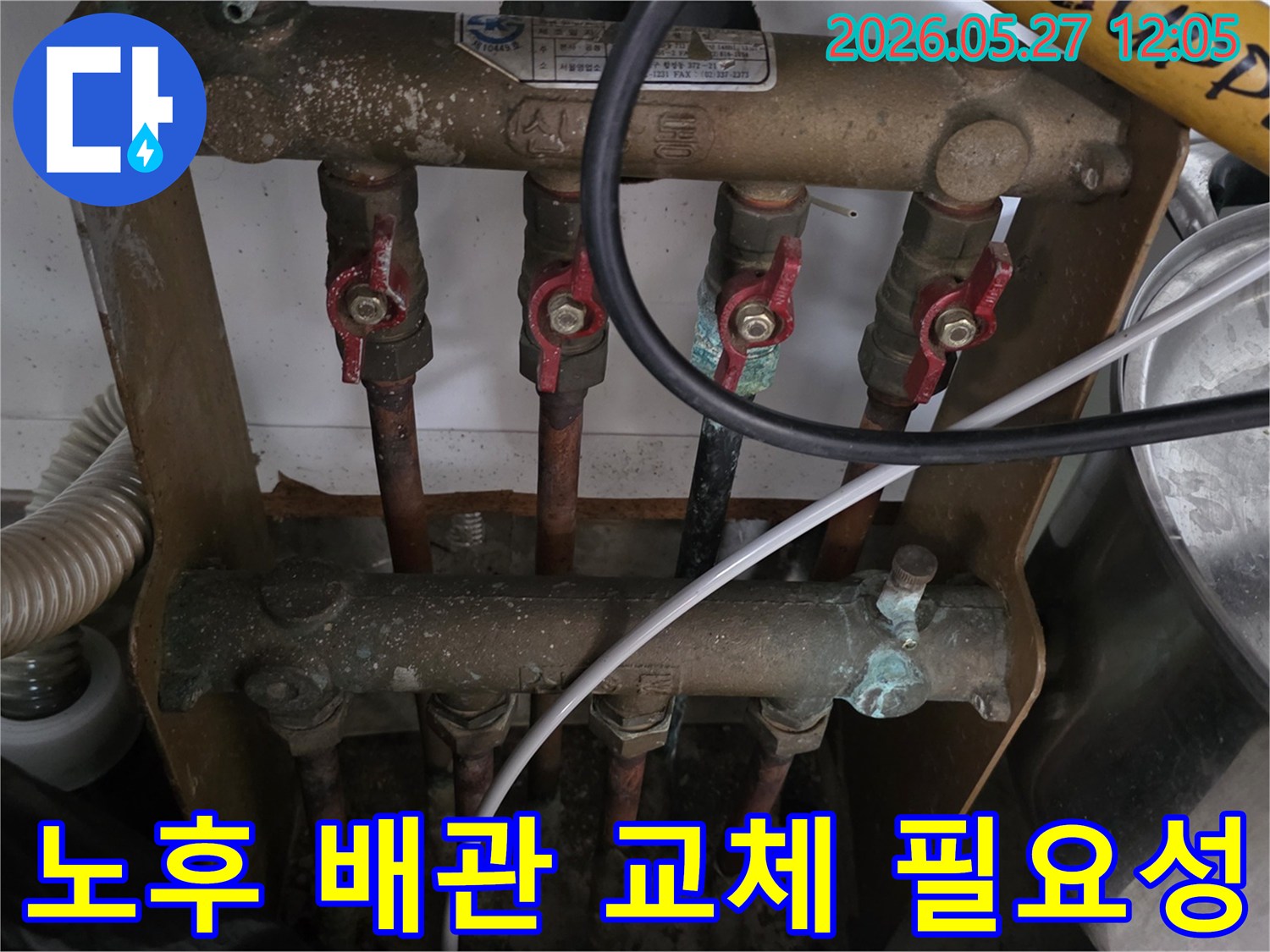 오래된 아파트의 보일러 분배기 주변-노후된 배관에서 심각한 부식이 진행되어-교체가 시급함을 알리는 현장을-전문가가 점검하고 있습니다