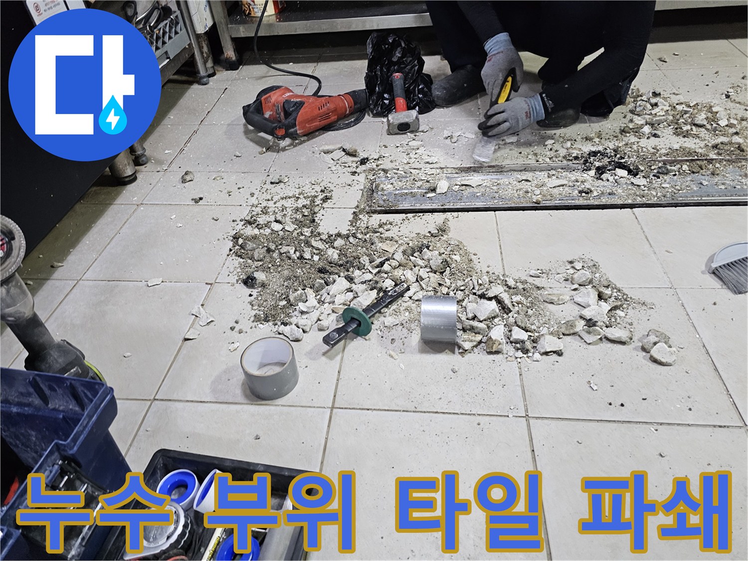 식당 주방-트렌치 주변의 파손된 타일과 드릴 장비
