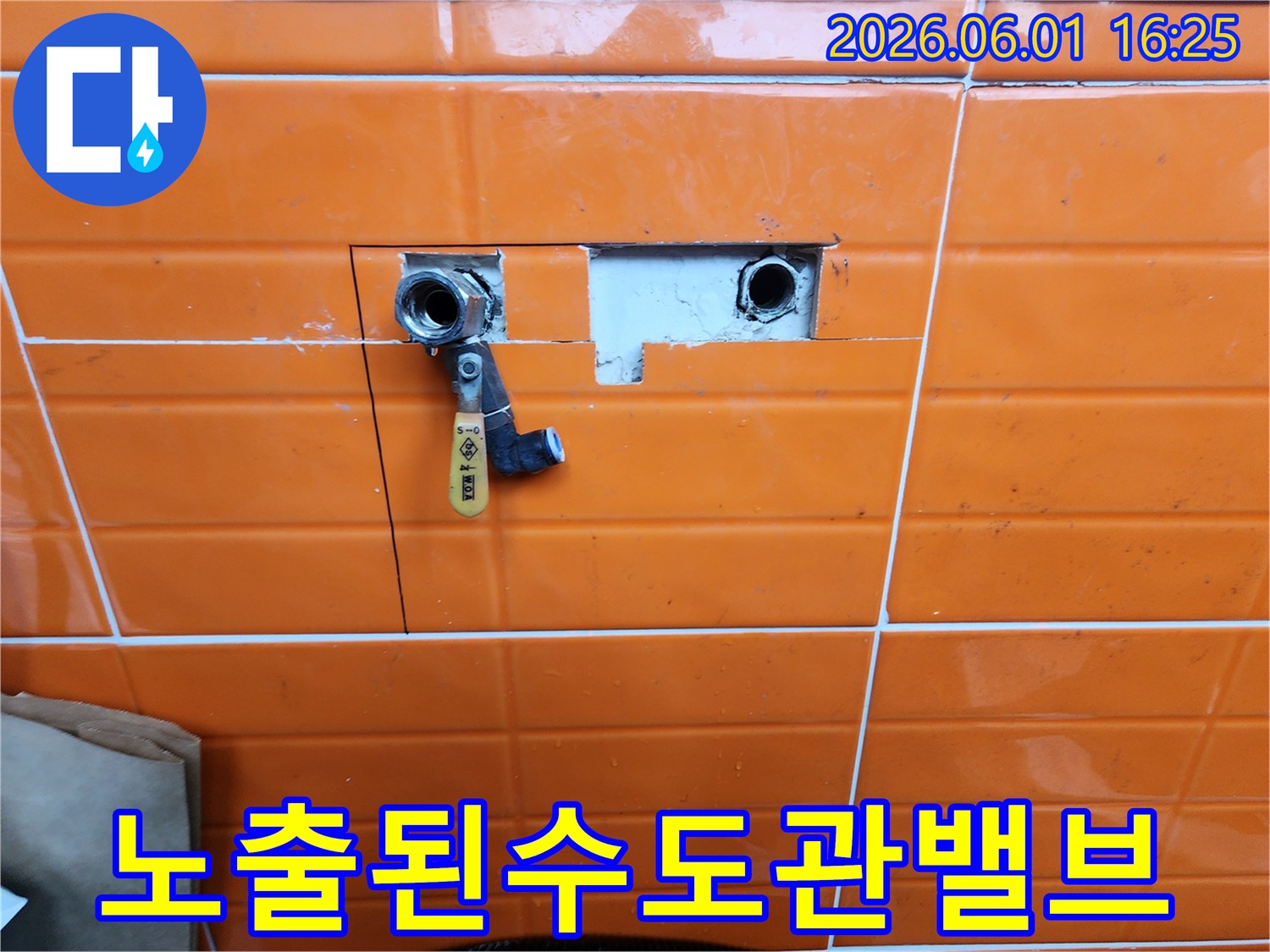 누수-공사-중-벽면-타일을-제거하고-노출된-수도-배관과-새로-설치된-밸브를-보여주는-사진입니다.
