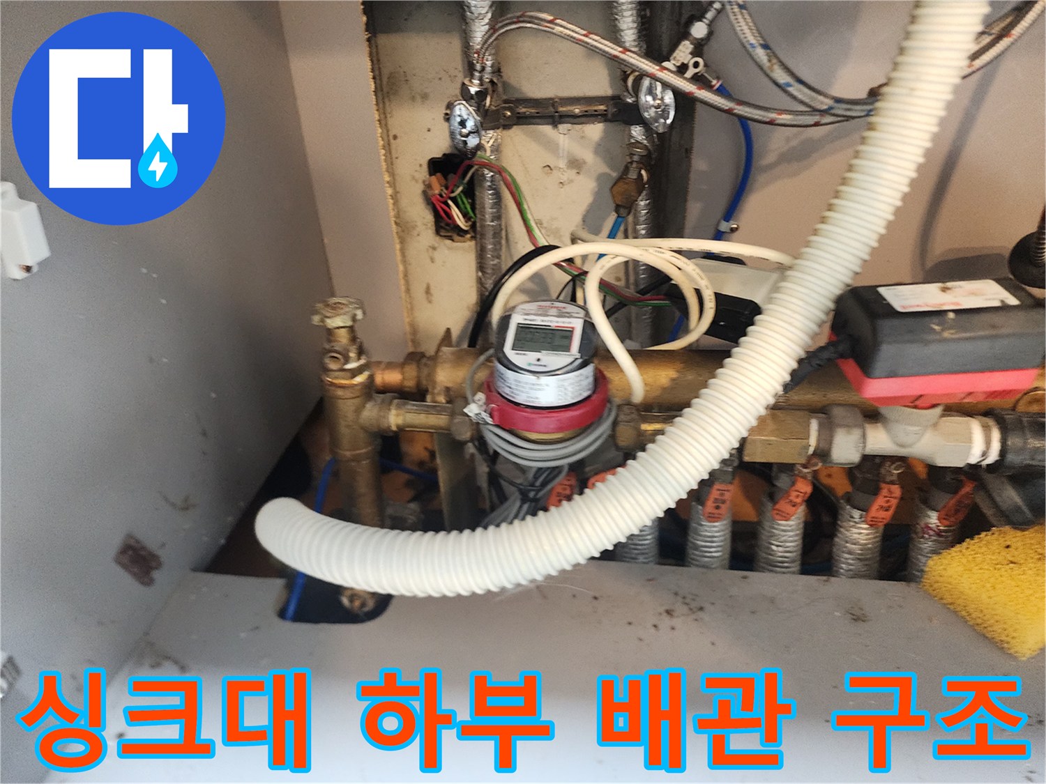 강북구 수유동 싱크대 아래쪽의 복잡한 배관과 계량기 모습입니다.