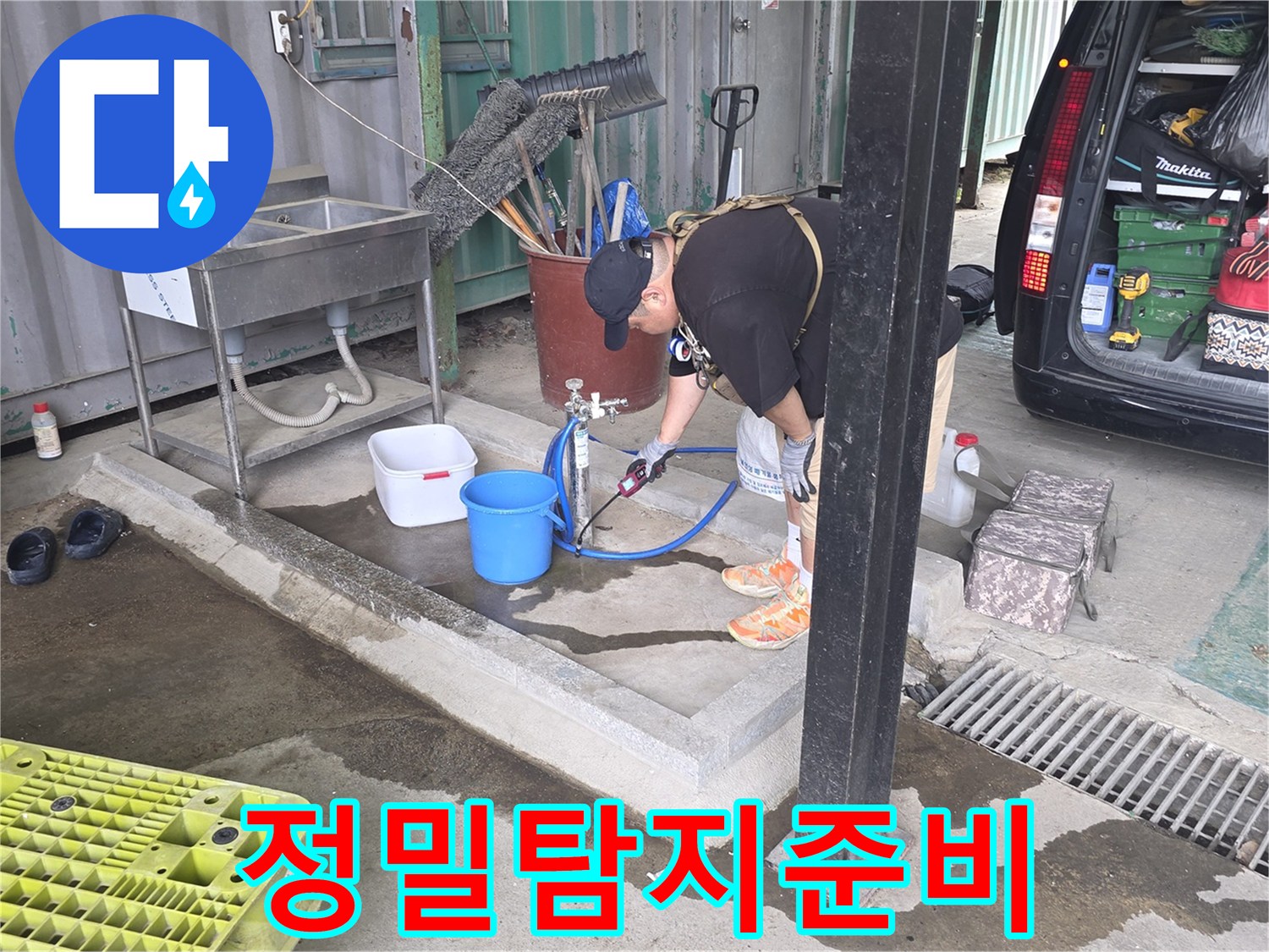한-남성이-야외-수도꼭지에-연결된-장비로-배관을-점검하고-있는-모습입니다.