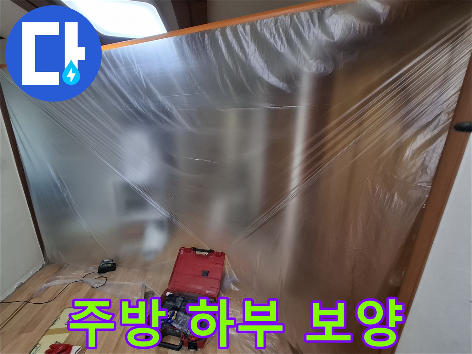 누수 공사를 위해 비닐로 감싸진 싱크대 하부 구조물