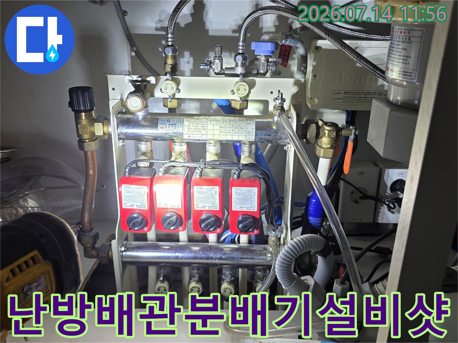금속 파이프와 빨간색 조절 밸브들이 복잡하게 얽힌 보일러 분배기 시스템