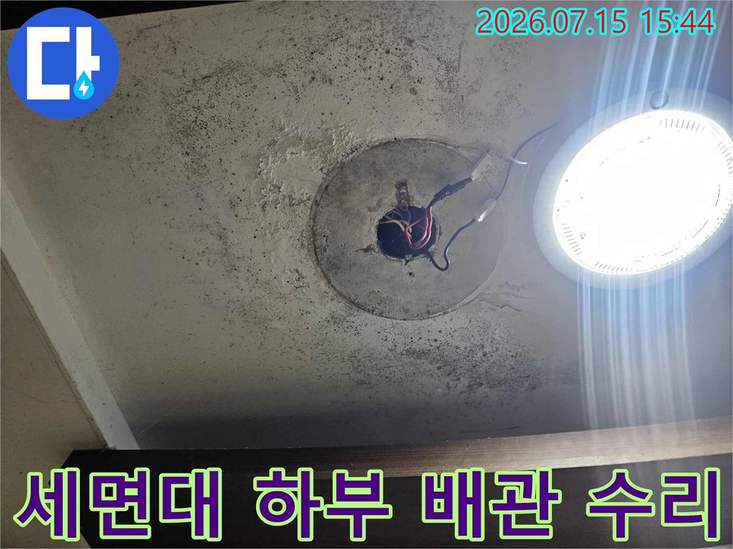 오염된 바닥 위 노출된 파손 배관 부위를 촬영한 사진