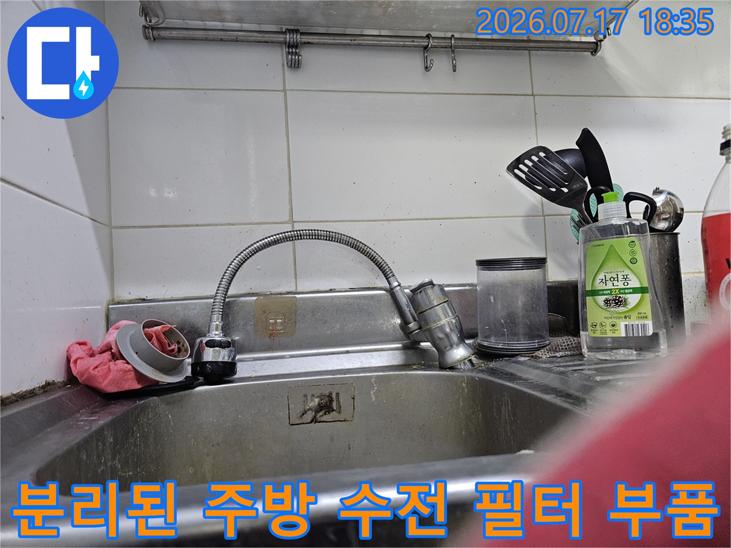 스테인리스-싱크대-위에-놓인-분리된-형태의-수전-거름망과-헤드-부속품