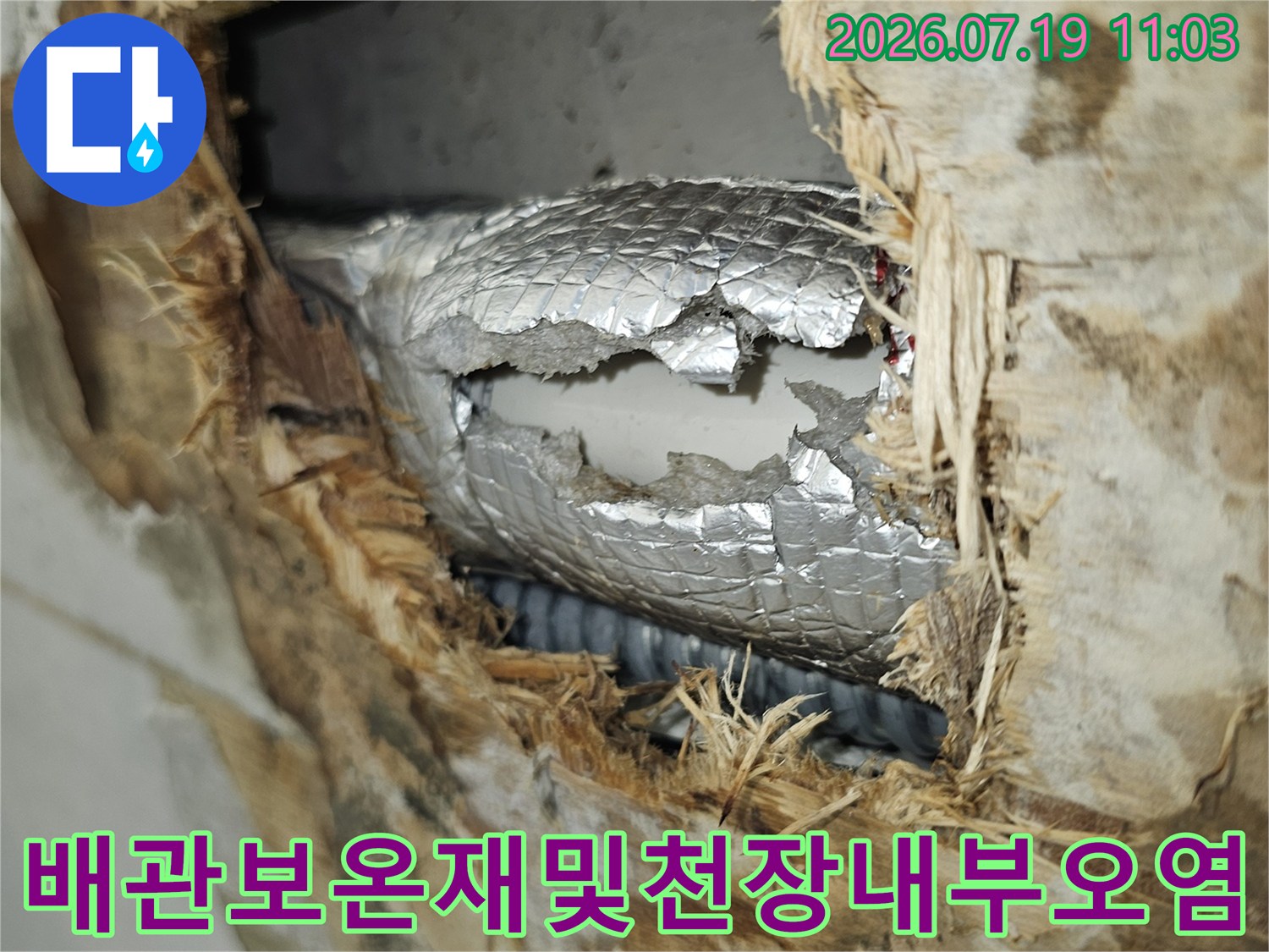누수로 인해 젖어 있는 천장 내부 구조물과 은색 단열재가 감싸진 배관