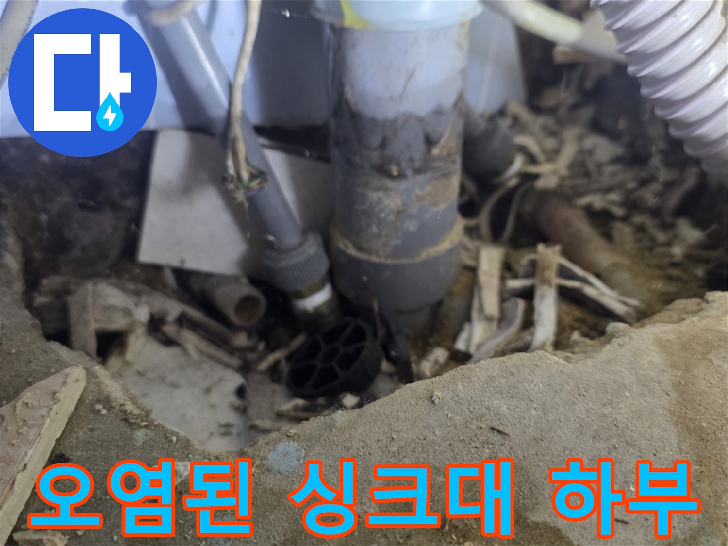 누수 발생으로 인해 젖어 있고 오염된 싱크대 배관 주변의 바닥면