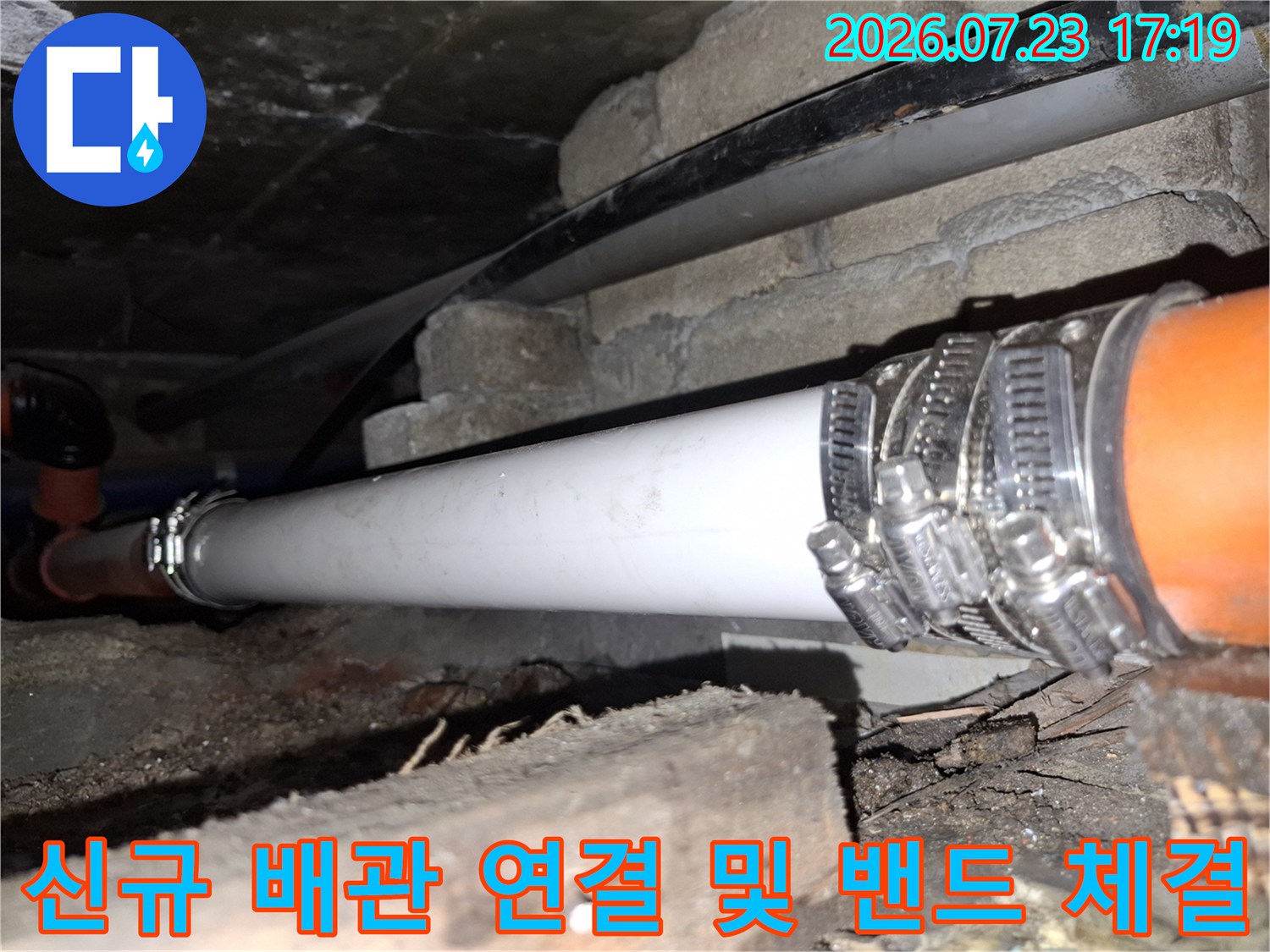 오렌지색 기존 관과 흰색 신규 관의 접합부를 호스 밴드로 고정한 상세 사진