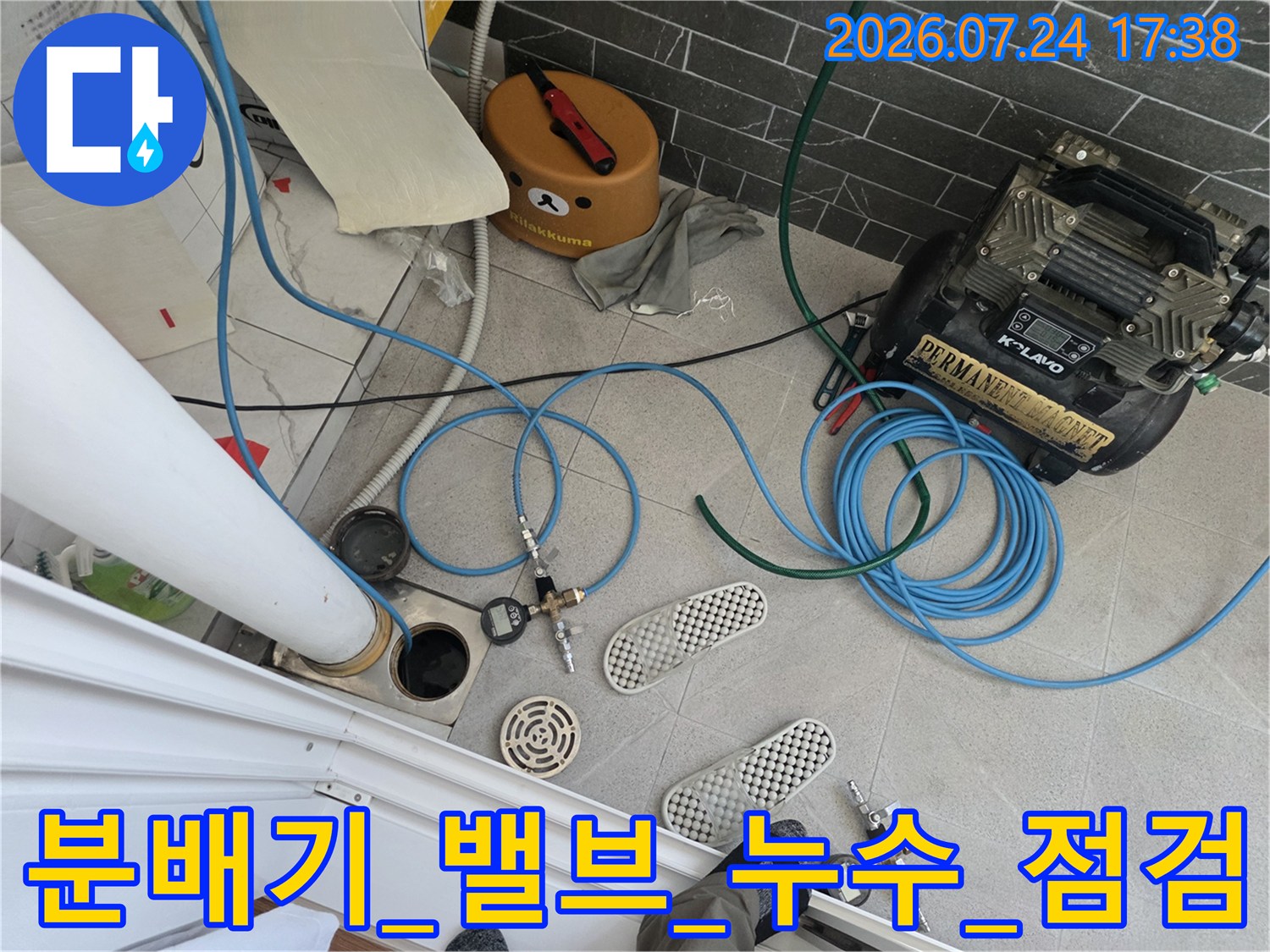 어질러진 배관 주변에서 공압 장비를 활용해 누수를 점검하는 모습