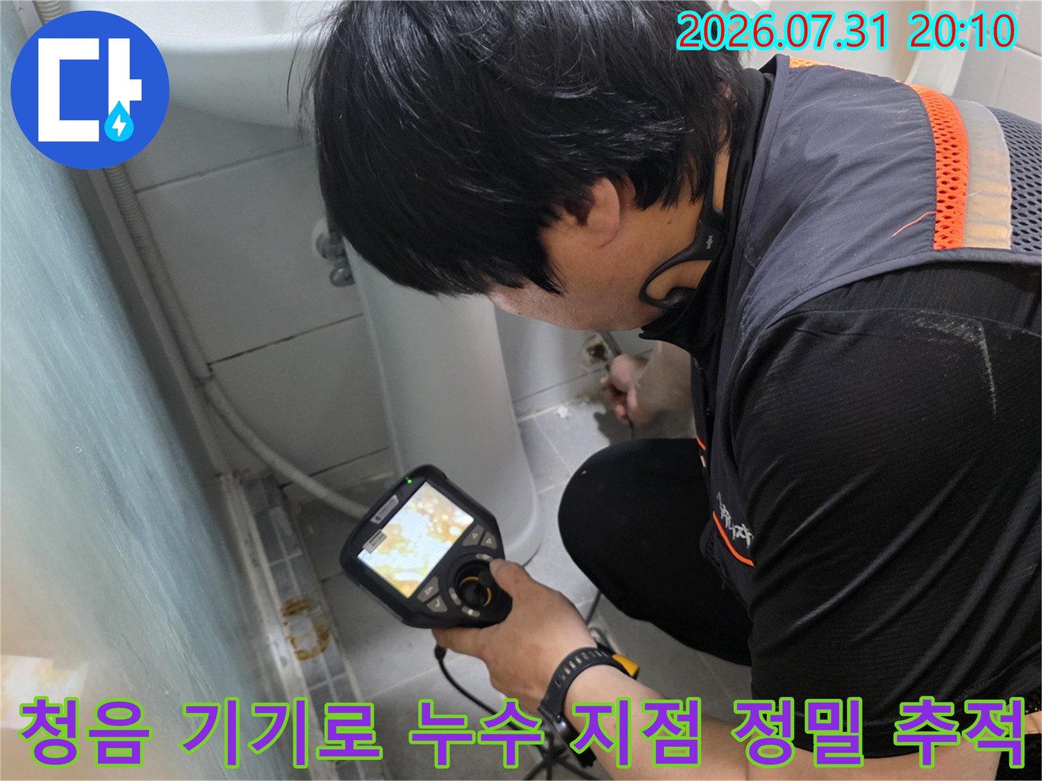 엔지니어가 전용 청음 장비를 사용하여 화장실 매립 배관의 문제 부위를 세밀하게 분석하는 모습