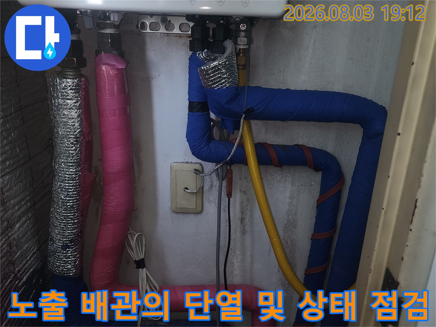 분홍색과 파란색 단열재로 마감된 보일러실 내 온수 및 난방용 배관 시설