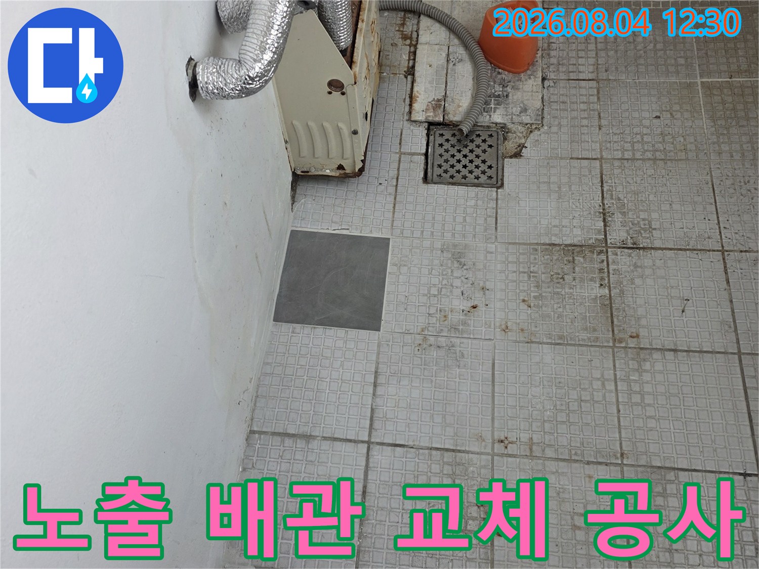 손상된 온수 배관을 노출하여 수선 중인 현장 사진