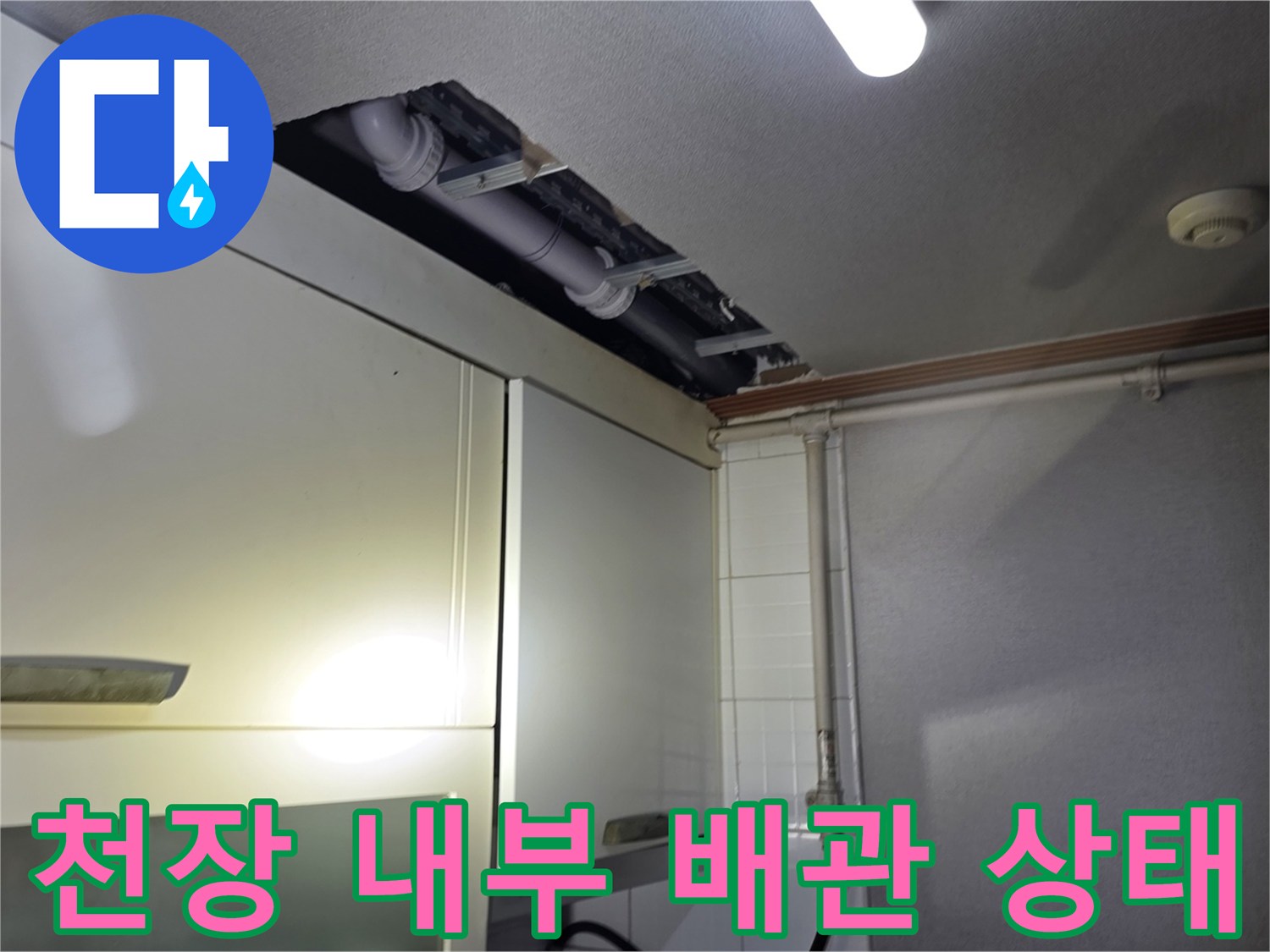 싱크대 상부장 위 천장 틈새에 노출된 배관 모습