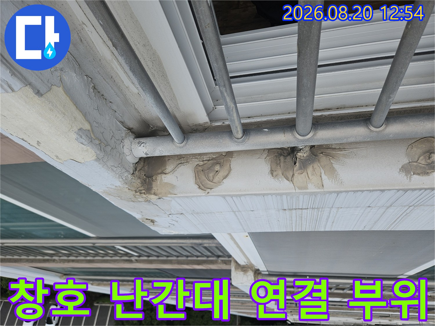 외부 난간대와 외벽 마감재 사이의 벌어진 틈새를 정밀하게 관찰하는 사진