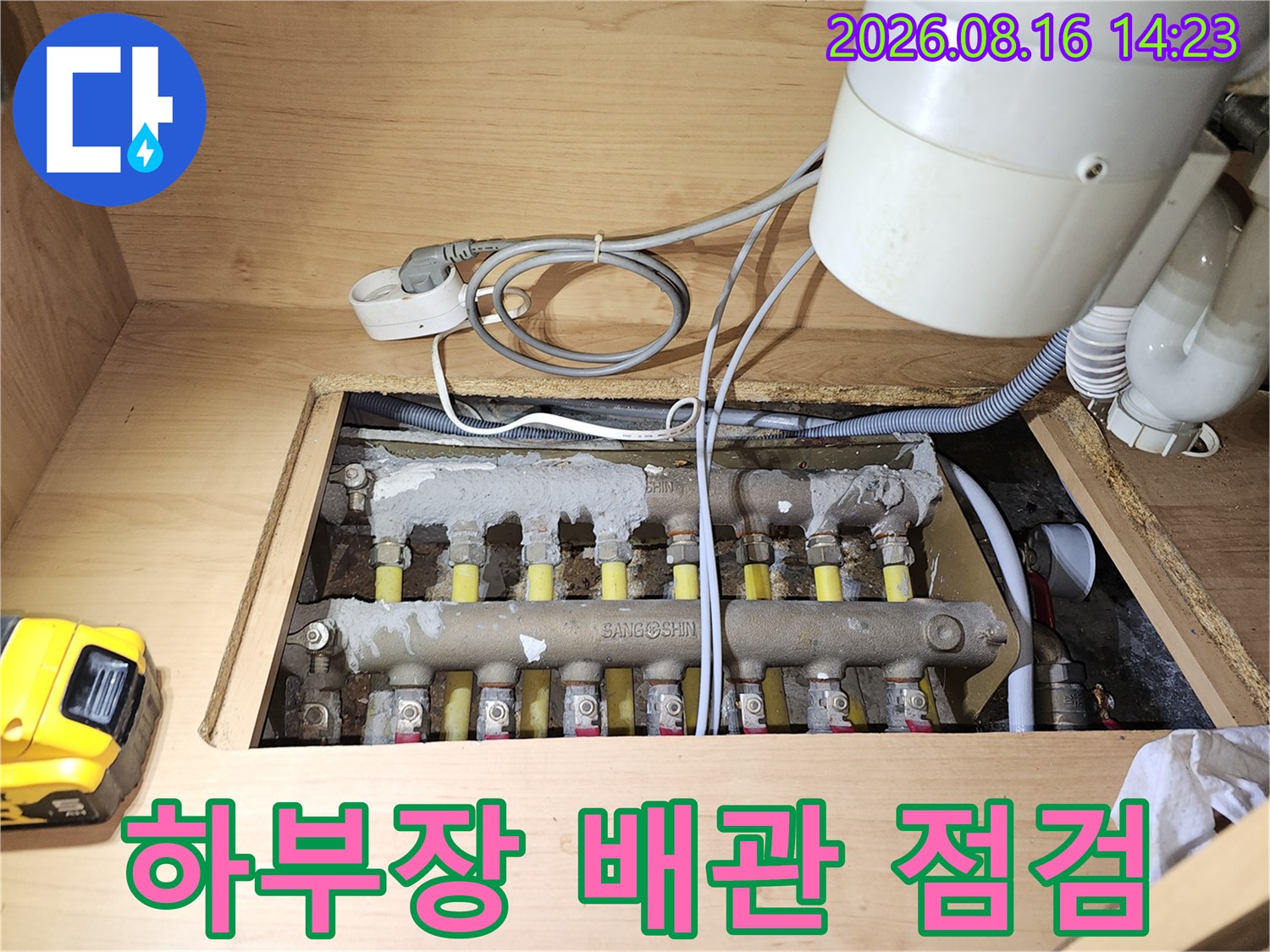 싱크대 하부장에 위치한 보일러 분배기와 연결된 배관들의 상세 모습입니다.
