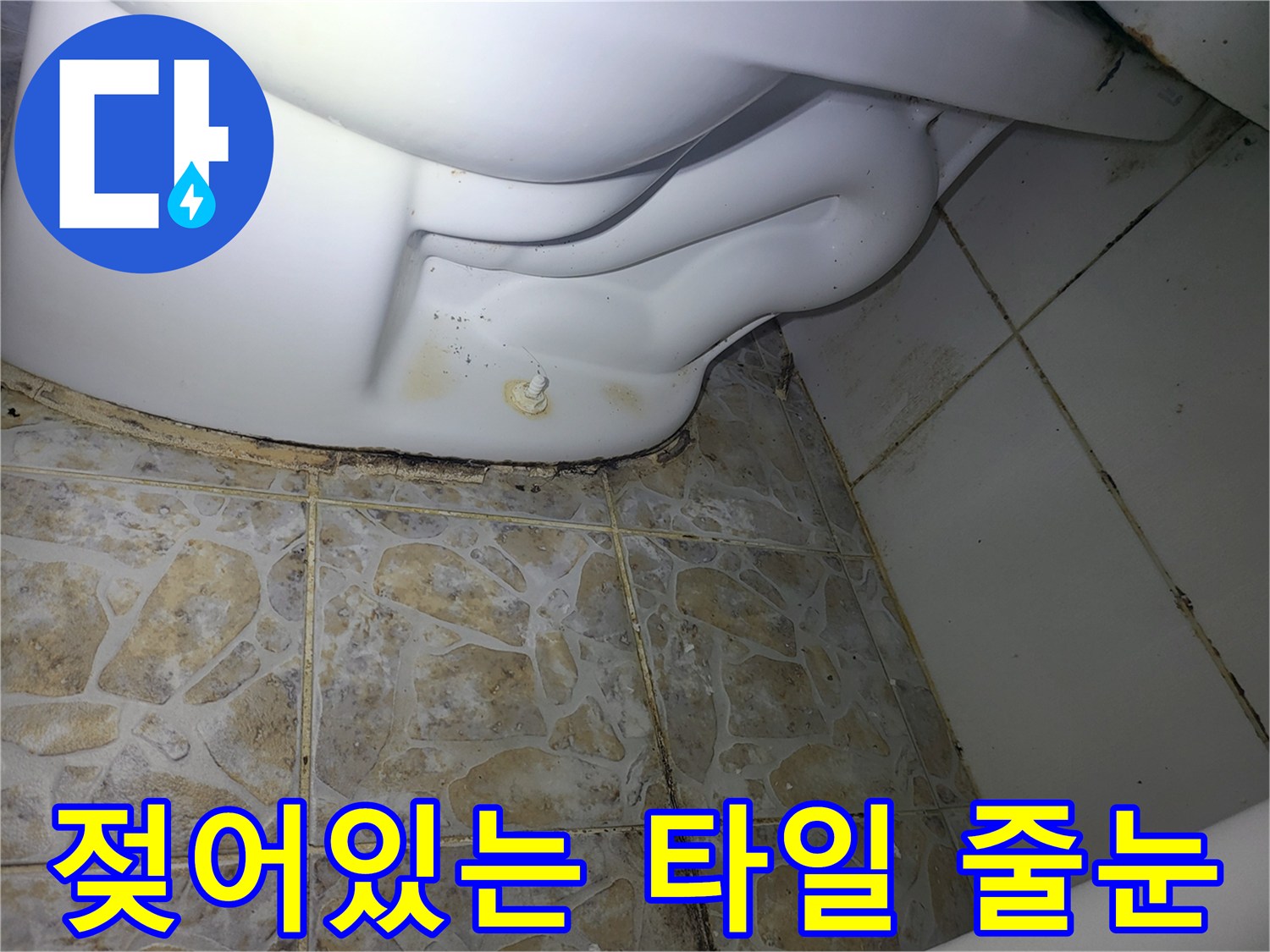 배관 주변의 젖은 듯한 타일 줄눈과 오염된 상태를 보여줍니다.