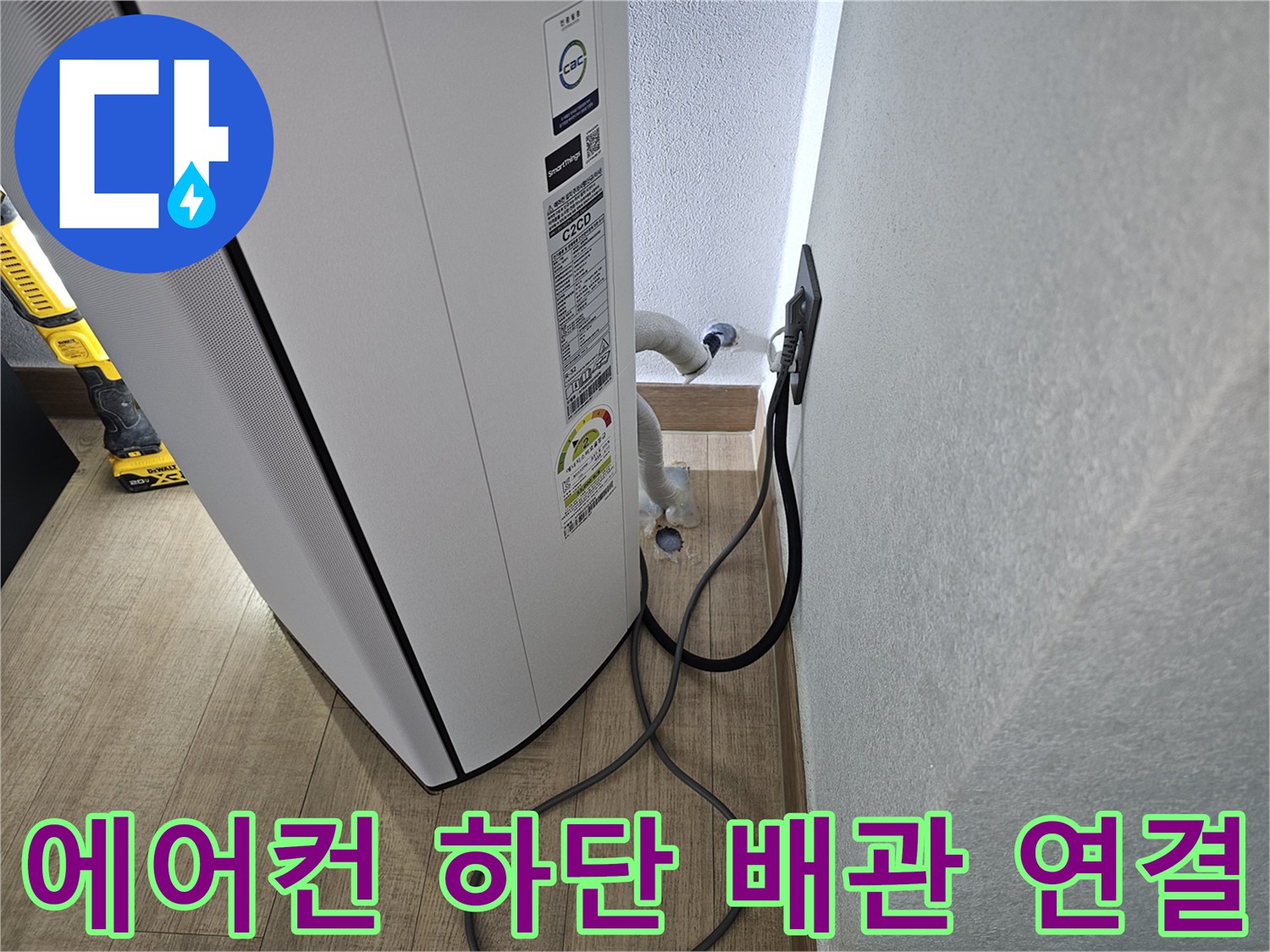 에어컨 본체와 벽면 콘센트 사이의 드레인 호스 연결 모습입니다.
