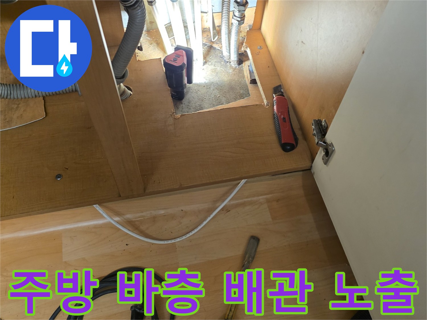 응봉동 현장 싱크대 하부 굴착 후 드러난 배관 라인과 작업 도구