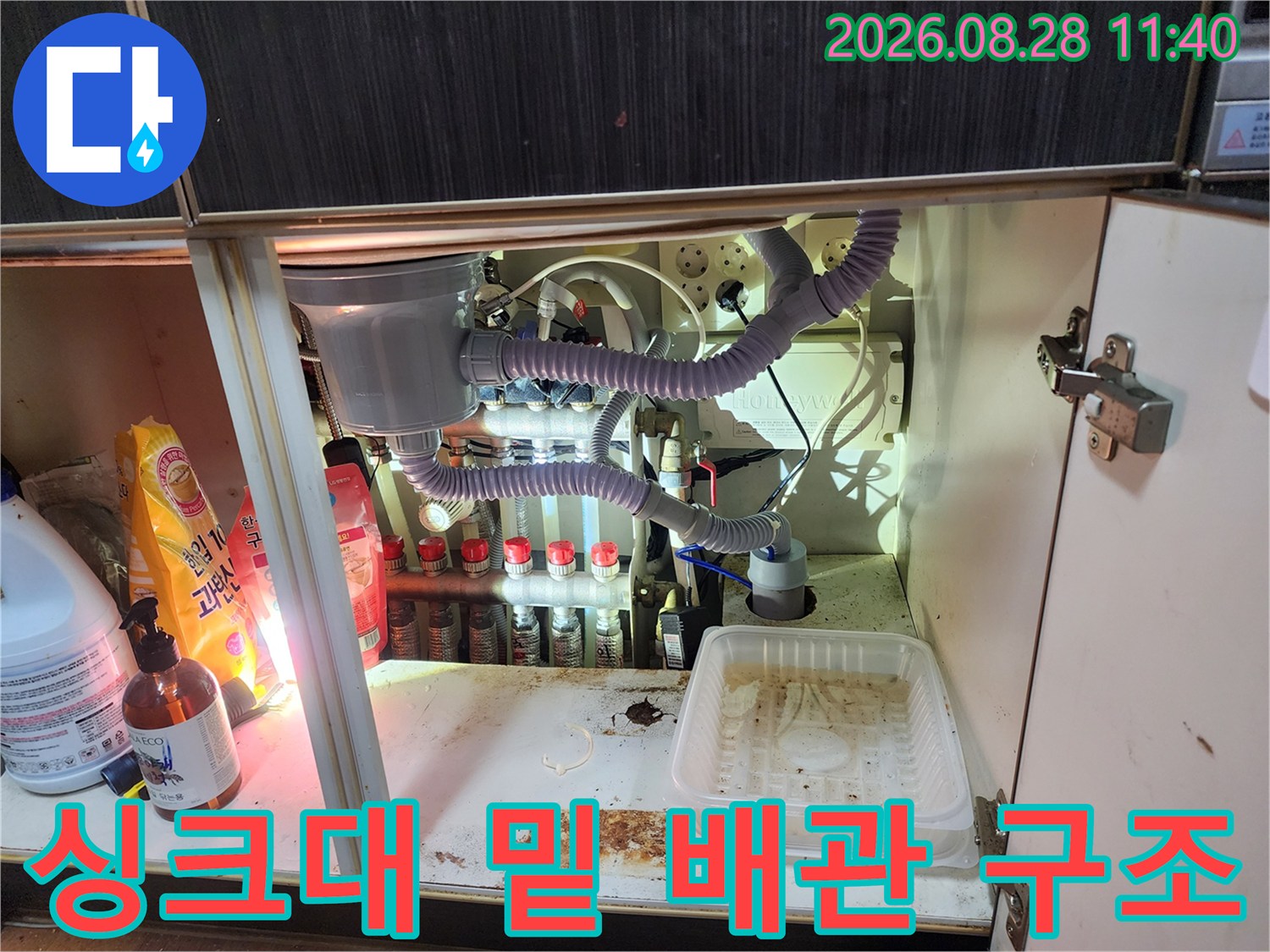 싱크대 하부의 정수기 및 에호스 연결 부위와 누수 흔적 사진