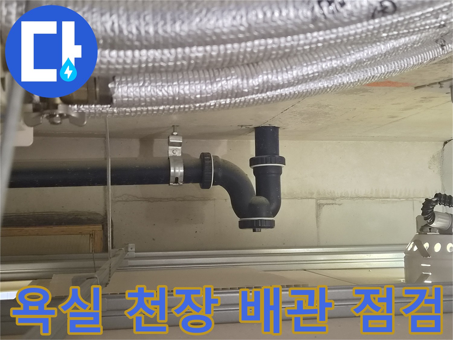 천장에 설치된 검은색 하수도 배관과 연결 부속