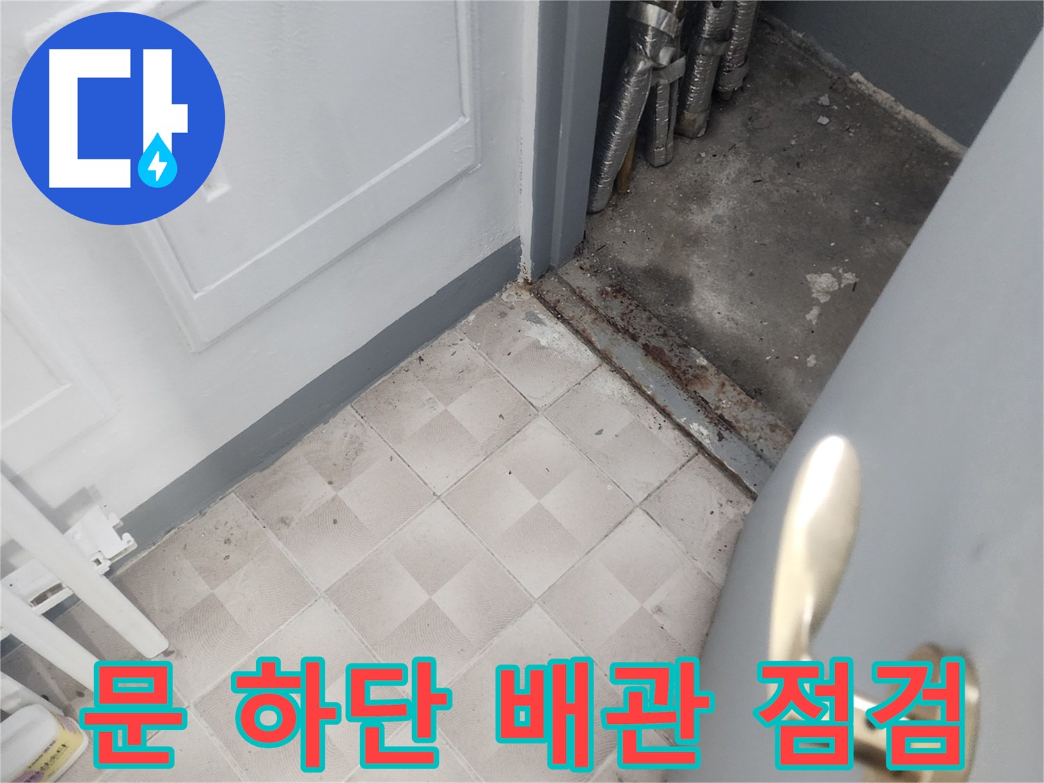 아파트 문틀 아래-노출된 다수의 배관과 타일면