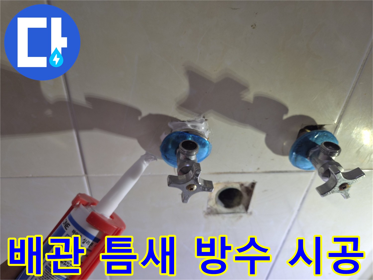 벽면 수전 배관 사이의 빈 공간을 실란트로 채우는 모습