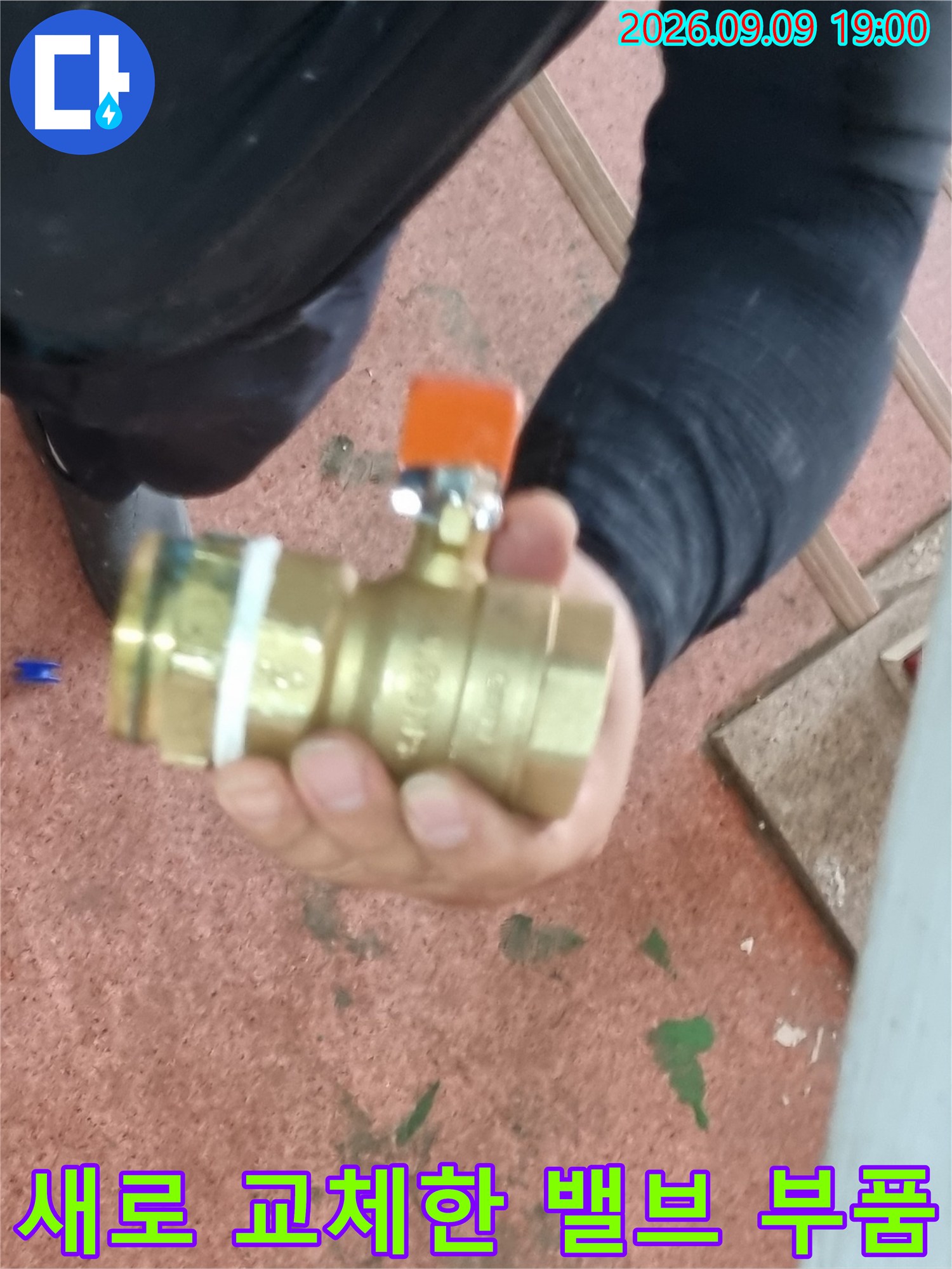 양주시 장흥면 현장에서 새로 설치한 주황색 손잡이의 금속 밸브 부품입니다.