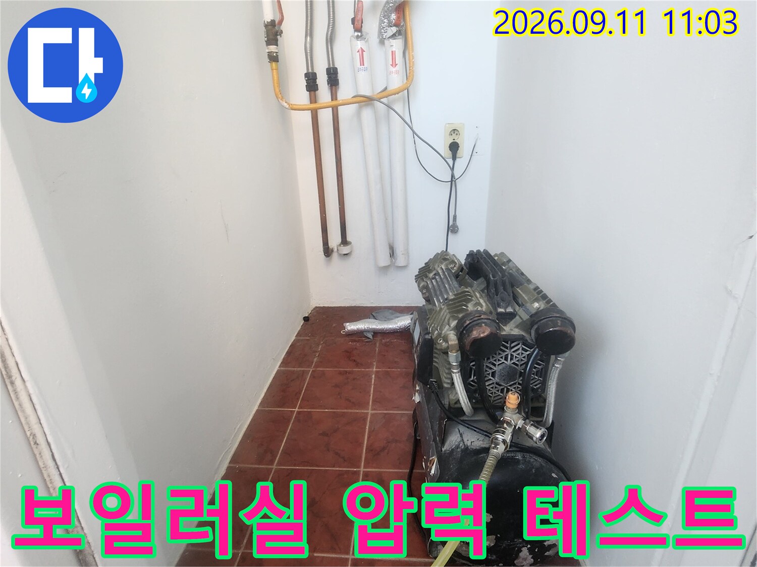 보일러 연결 배관에 설치된 공압 측정 장비와 노란 호스