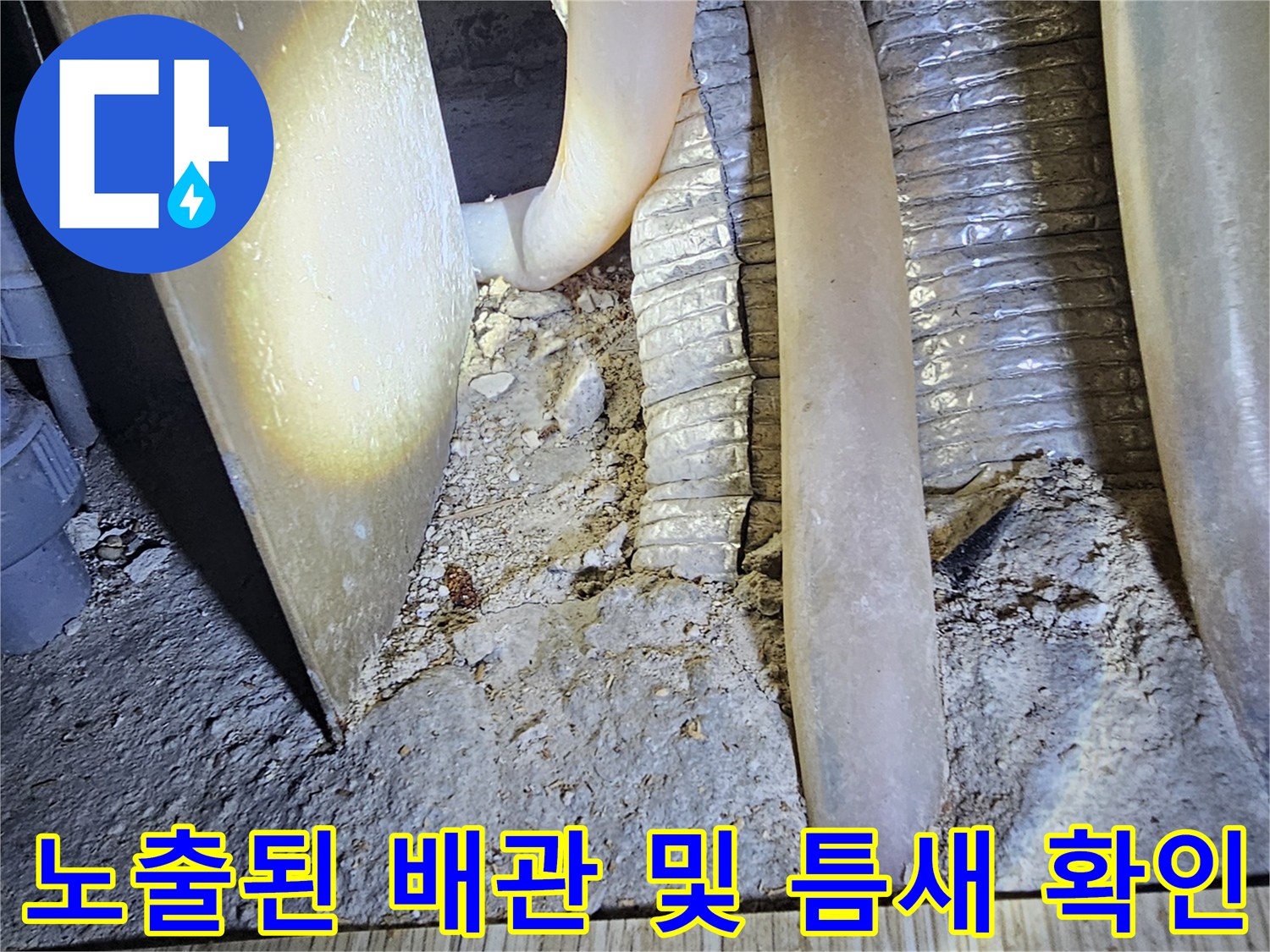 배관 사이의 틈과 주변 마감재의 오염 상태를 근접 촬영한 이미지